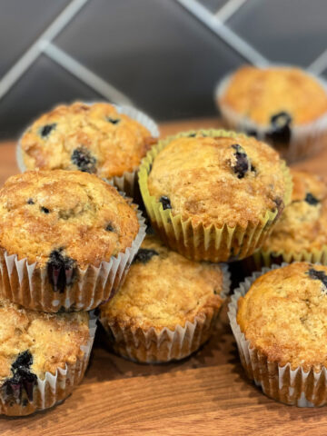Stacked banana blueberry muffins fresh from the oven.