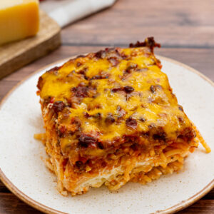 million dollar spaghetti casserole served on a white plate.