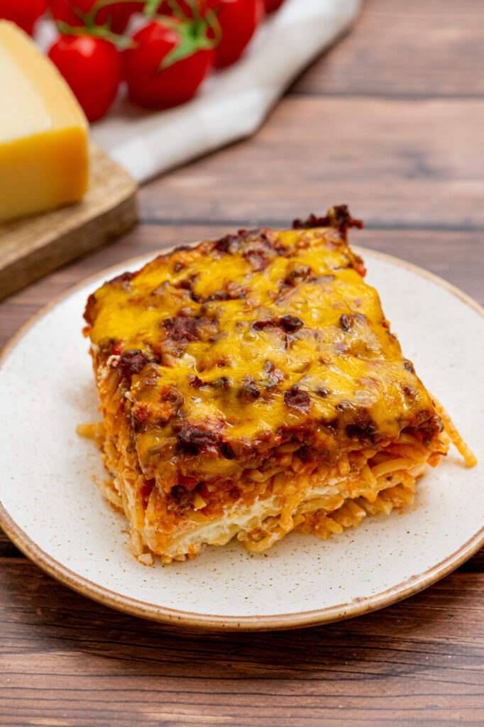 million dollar spaghetti casserole served on a white plate.
