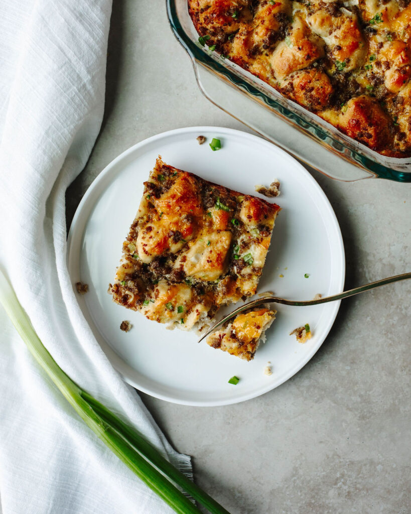 a serving of sausage biscuit casserole on a white plate.