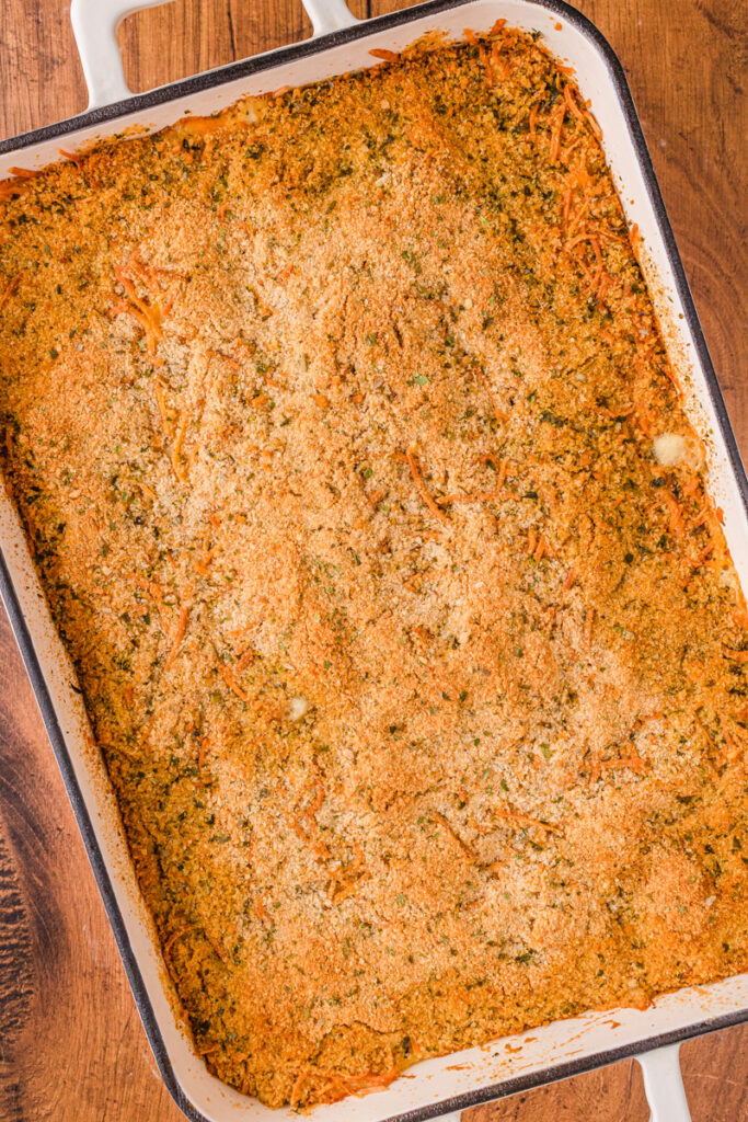 a pasta casserole with chicken, cheese, and a creamy sauce throughout.