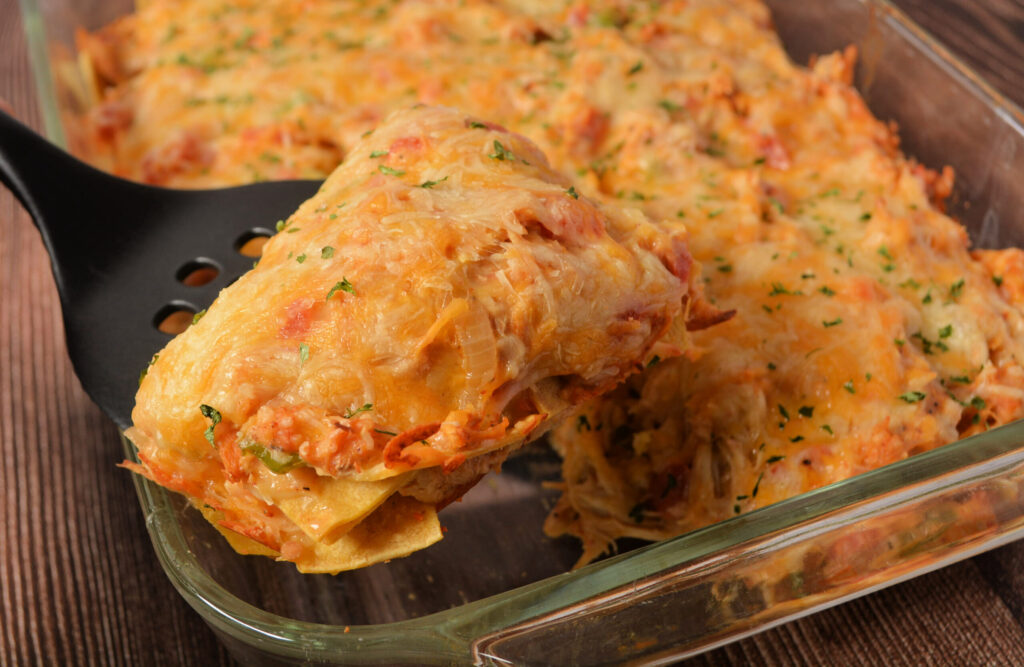 a slice of king ranch chicken casserole with corn tortillas