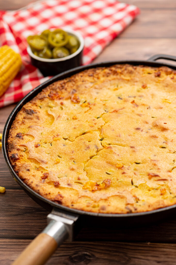 cast iron skillet cornbread loaded with cheese, bacon, and peppers