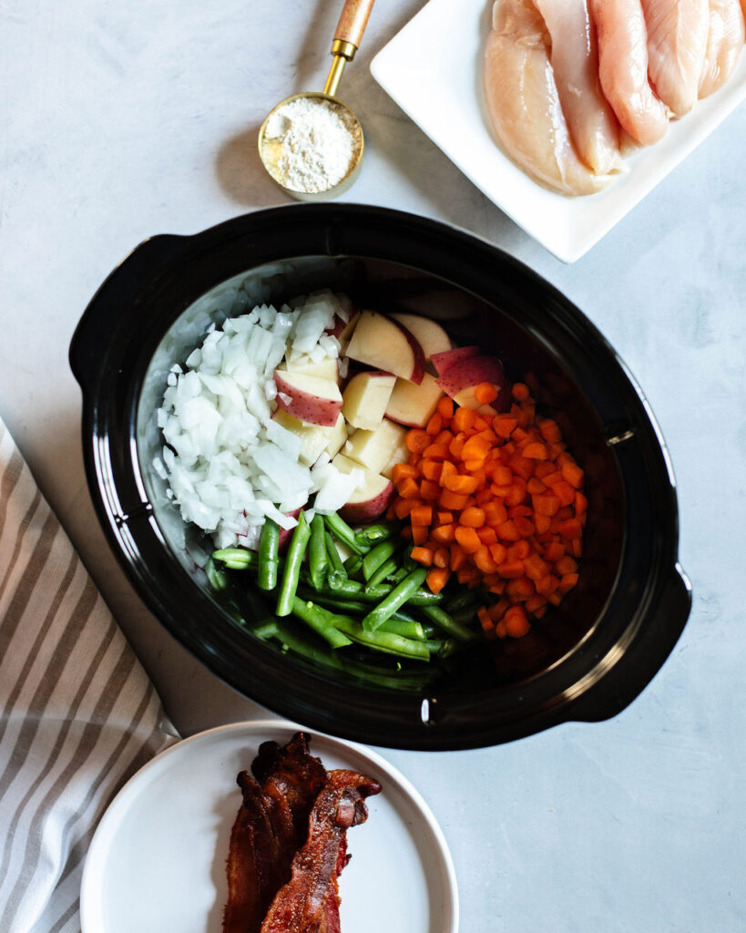 vegetables and chicken in a slow cooker.