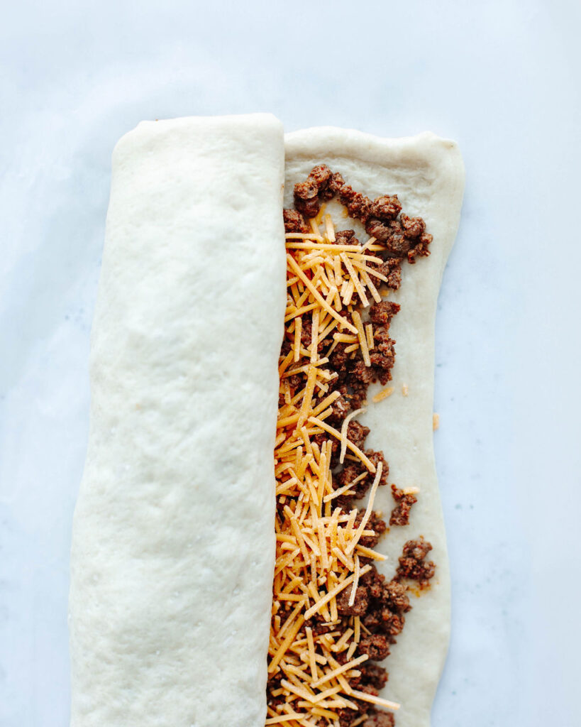 seasoned beef with shredded cheese wrapped in pizza crust.