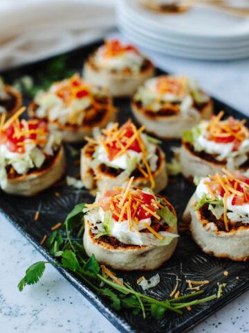 Mexican roll ups with favorite toppings added and ready to serve.