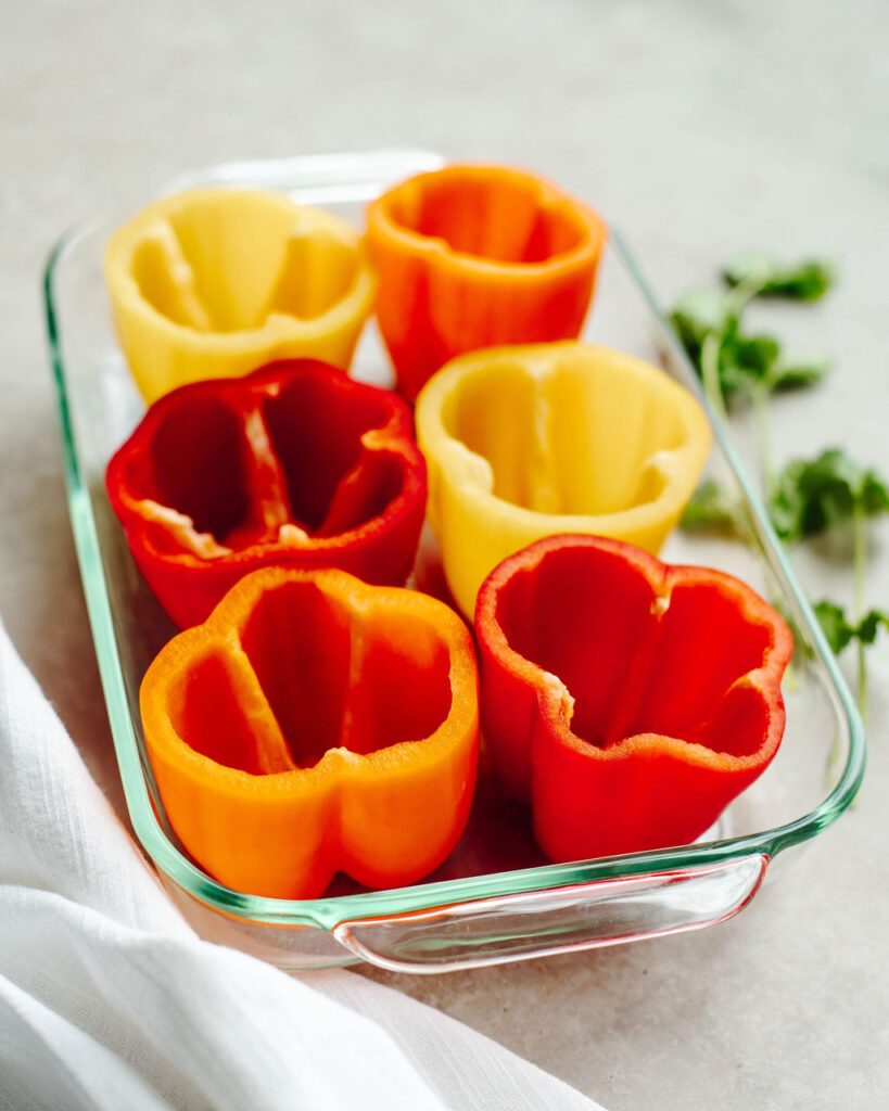 cleaned out bell peppers in a glass baking dish.