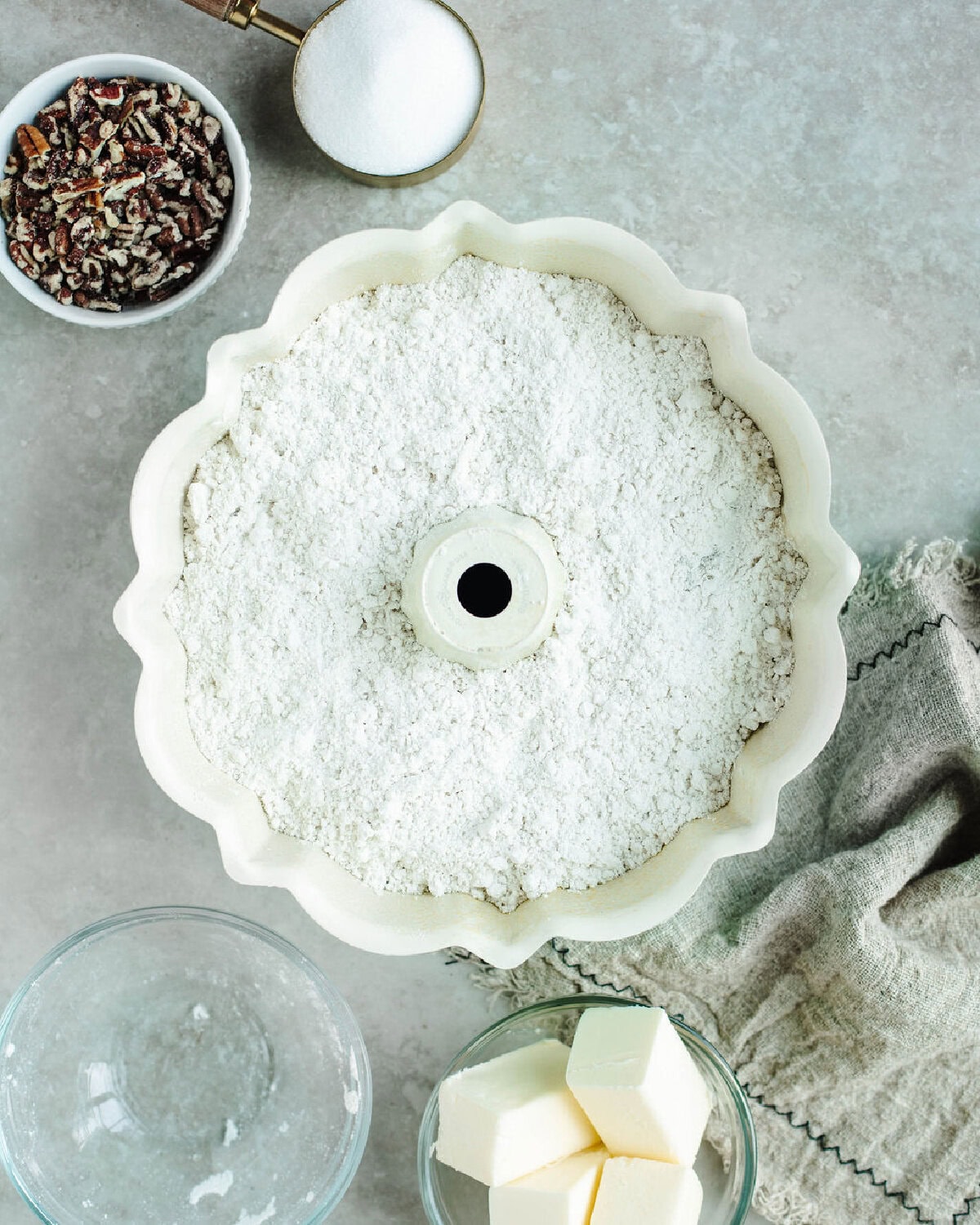 Sprinkling Bisquick mix over apple pie filling to make an easy apple cobbler with Bisquick.