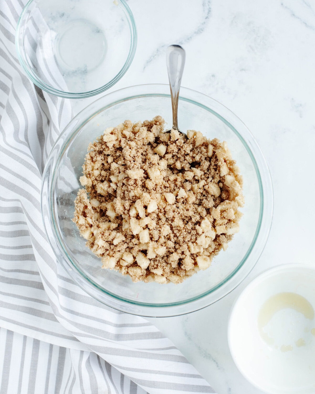 a crumb topping formed using a fork in a mixing bowl.