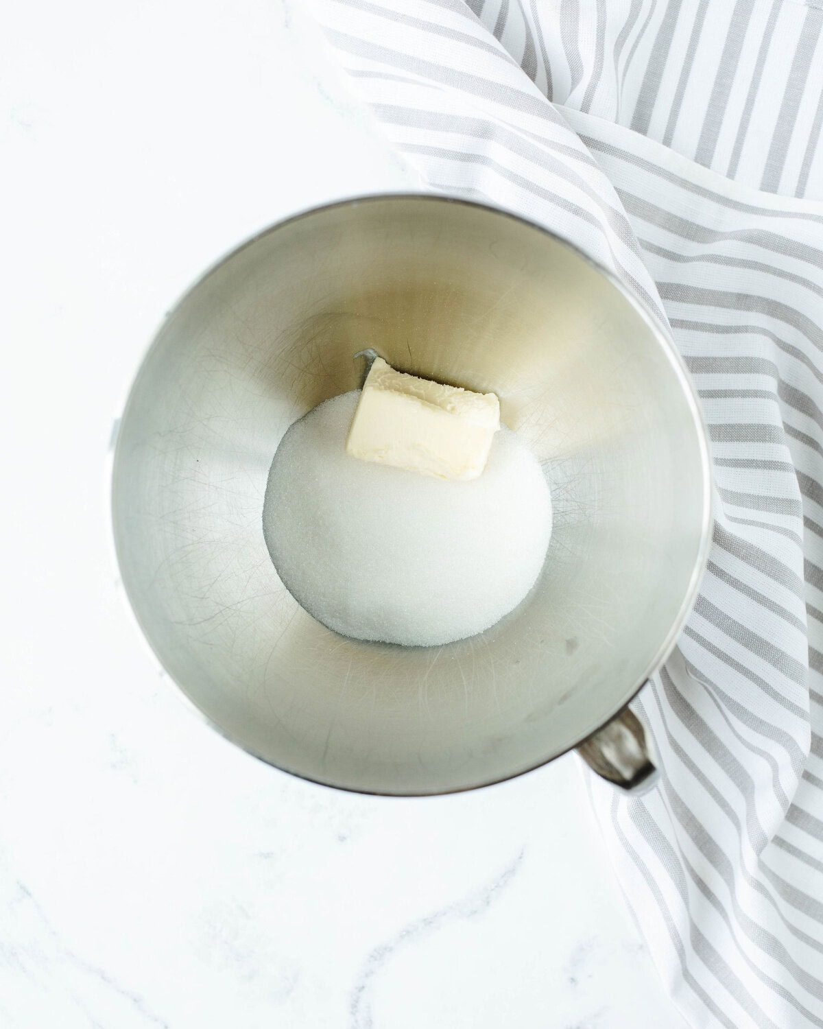 butter and sugar creamed together in a bowl.