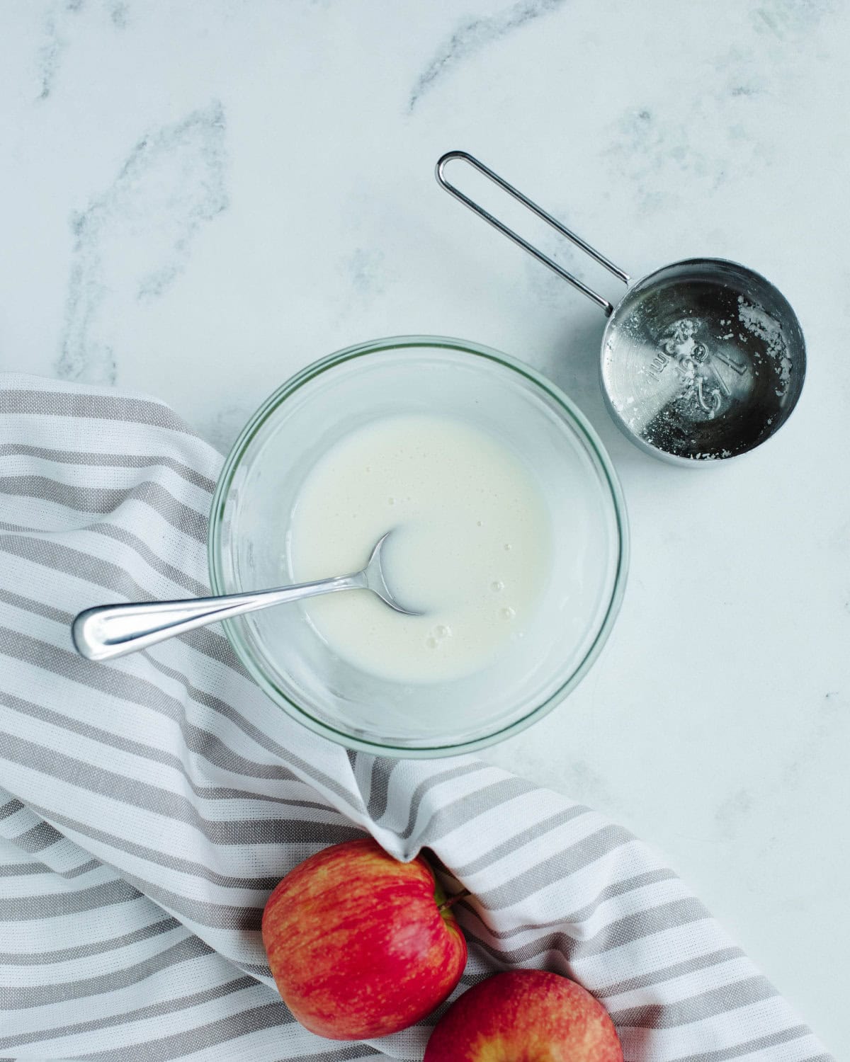 an apple cider glaze mixed in a glass bowl.