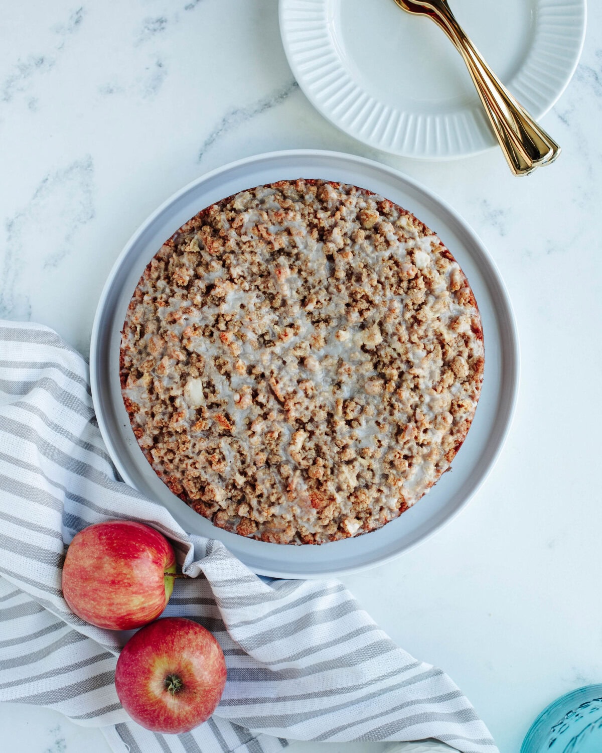apple cider glaze poured on top of a warm apple cinnamon crumb cake.
