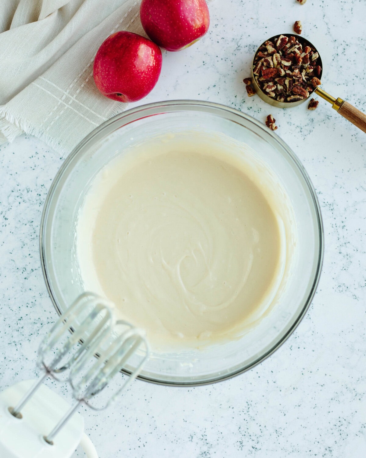 blended cream cheese and sugar mixture in a glass mixing bowl.