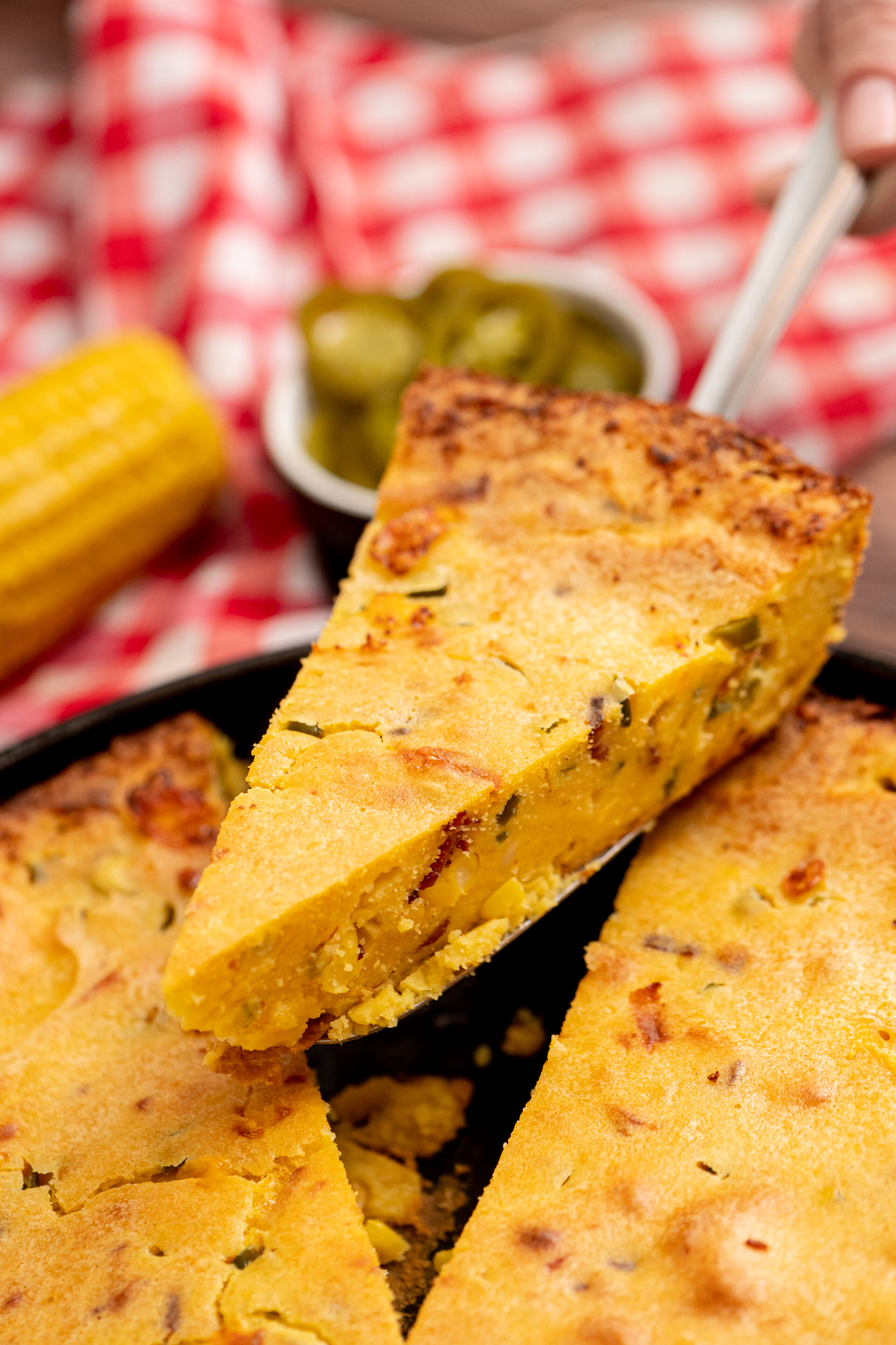 a slice of loaded cornbread being served.