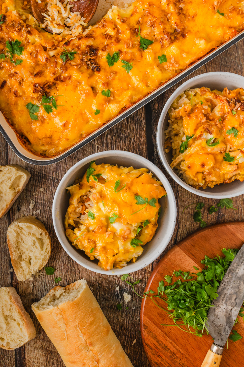 cheesy chicken and rice casserole served in white bowls.