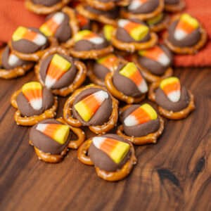 a wood board with Halloween pretzel treats on top.