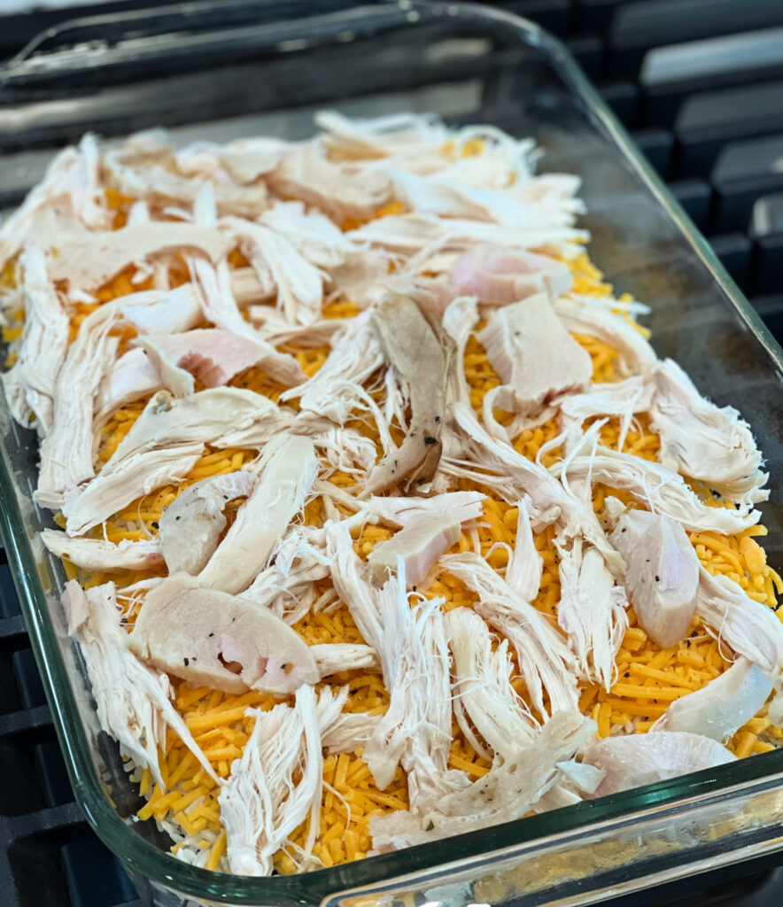 shredded chicken on top of cheese and rice