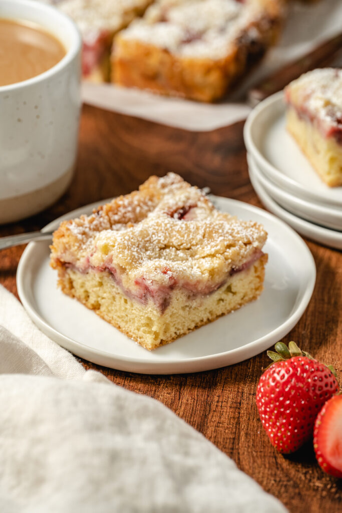 a slice of strawberry crumb coffee cake on a plate