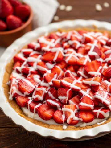 fresh strawberries mixed with white chocolate in a pie crust