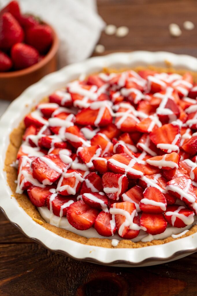 fresh strawberries mixed with white chocolate in a pie crust
