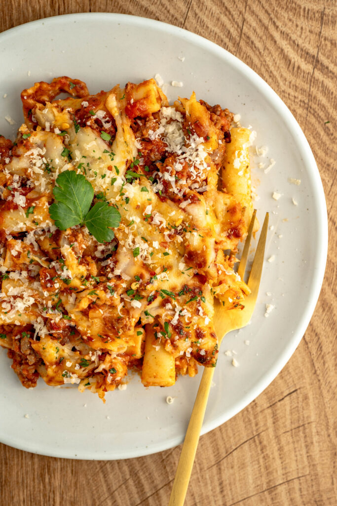 cheesy and tender pasta with a beef and spaghetti sauce on top.