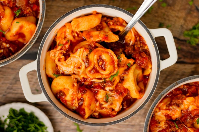 cheesy tortellini made in the slow cooker and served in a white bowl.