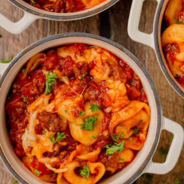 a serving of Cheesy Crockpot Tortellini in a white bowl.