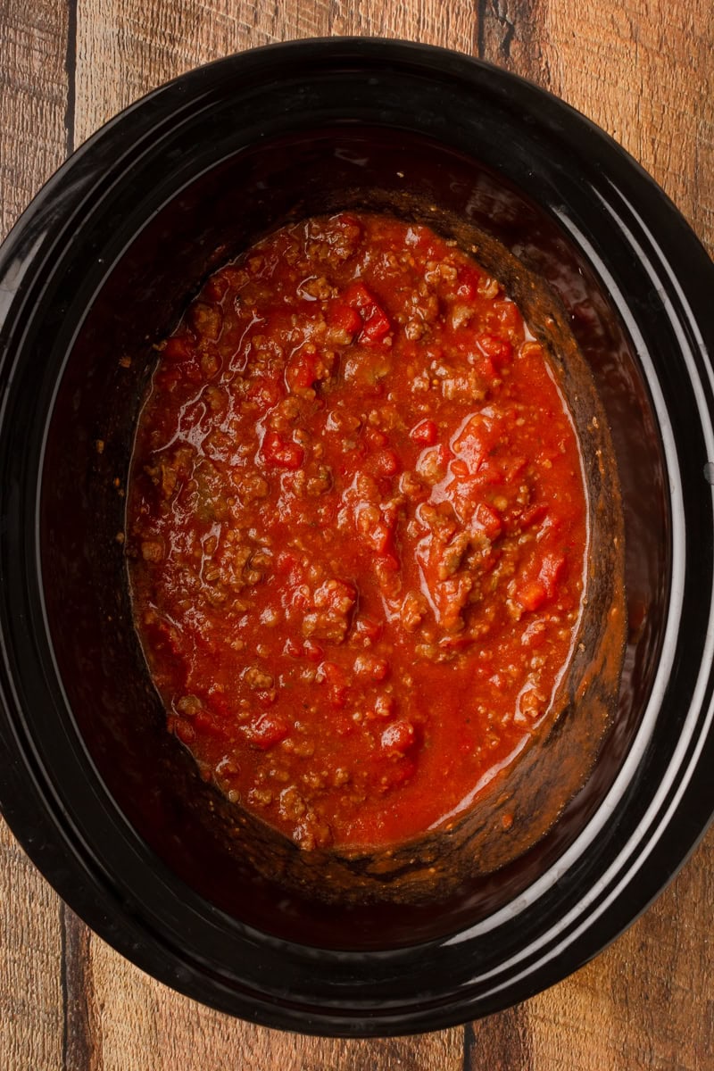 spaghetti sauce with Italian sausage cooking in a slow cooker.