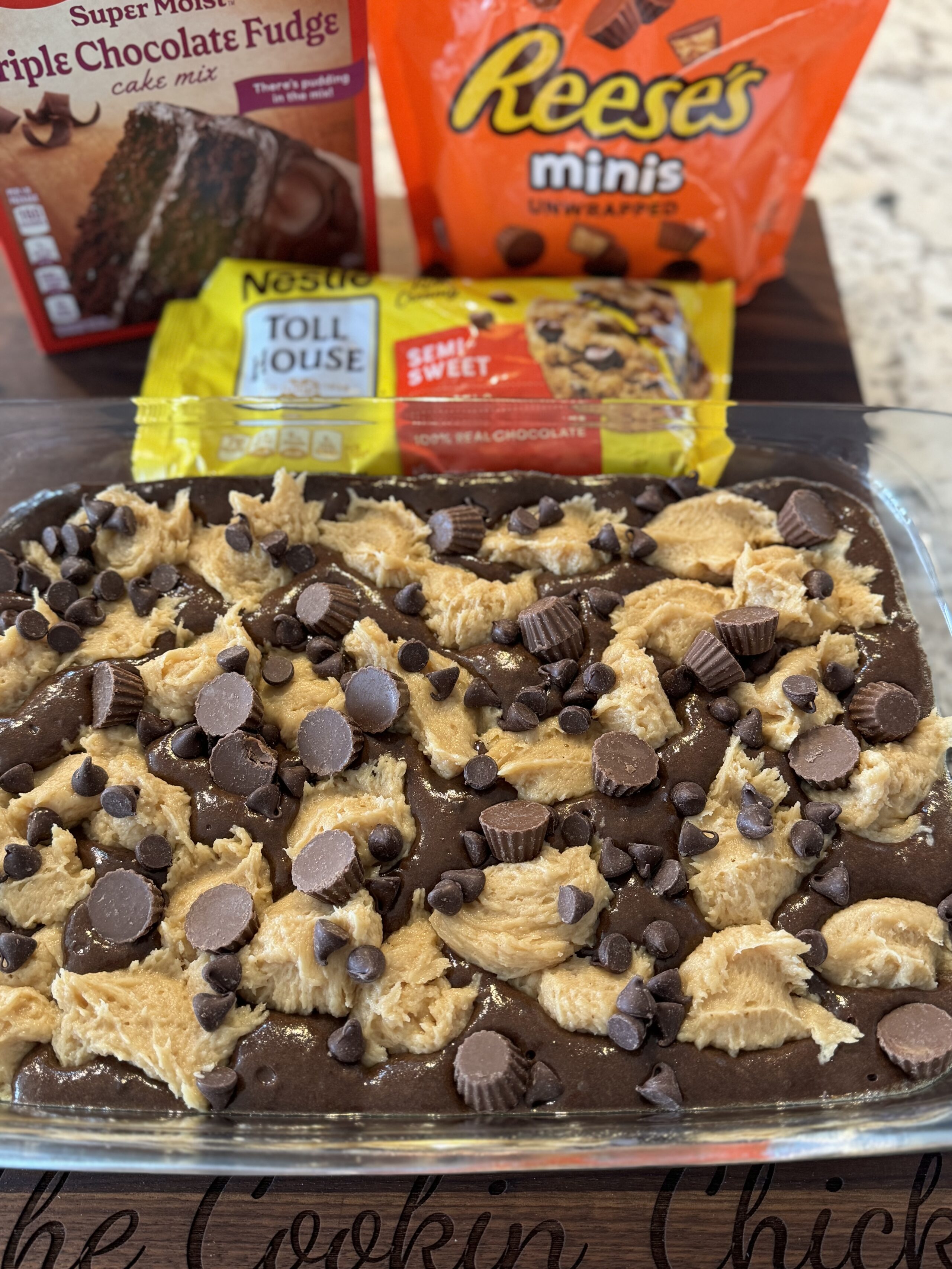 chocolate peanut butter earthquake cake in a glass baking pan ready to bake in the oven.