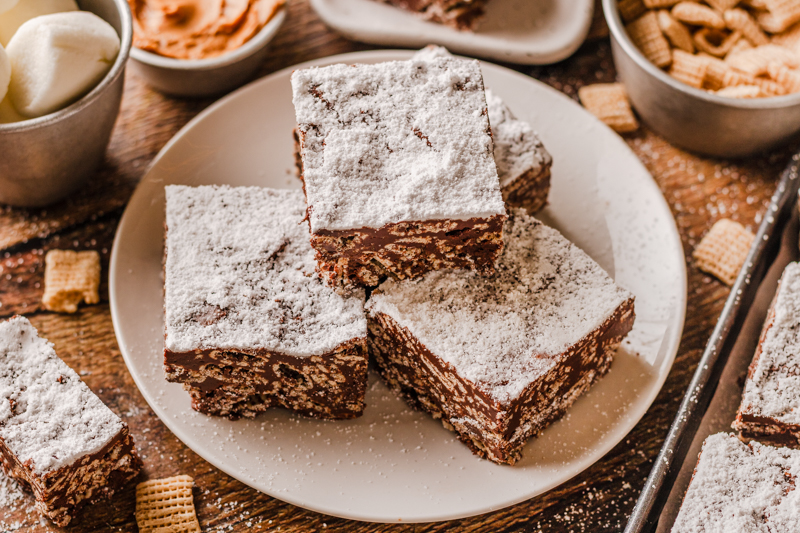 pieces of puppy chow bars on a white plate.