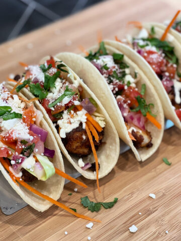 easy fish tacos served with slaw and sauce on top