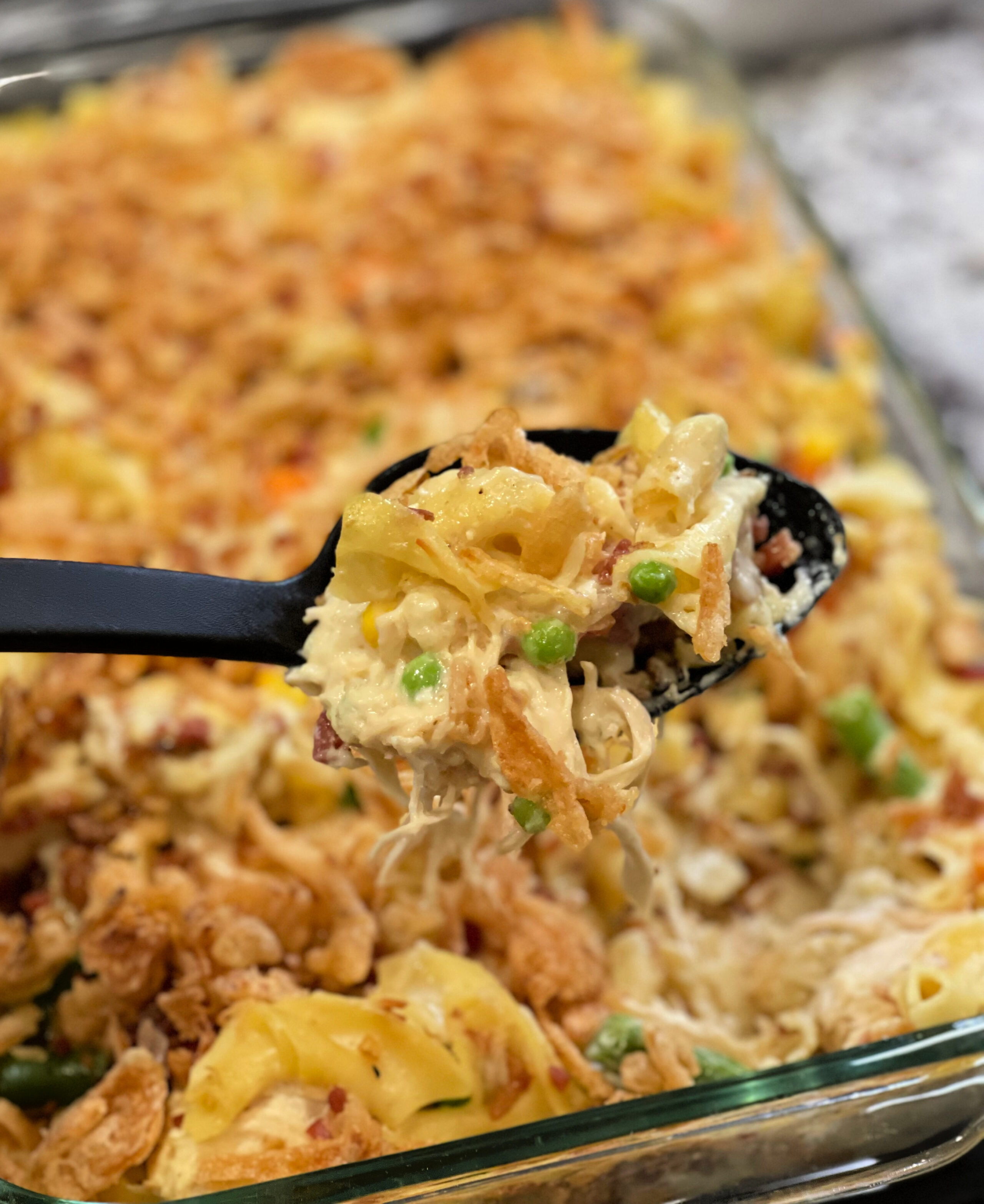 cheesy chicken casserole in a glass baking pan.