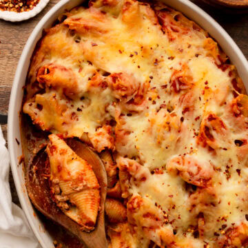 stuffed lasagna shells baked in a white baking dish.