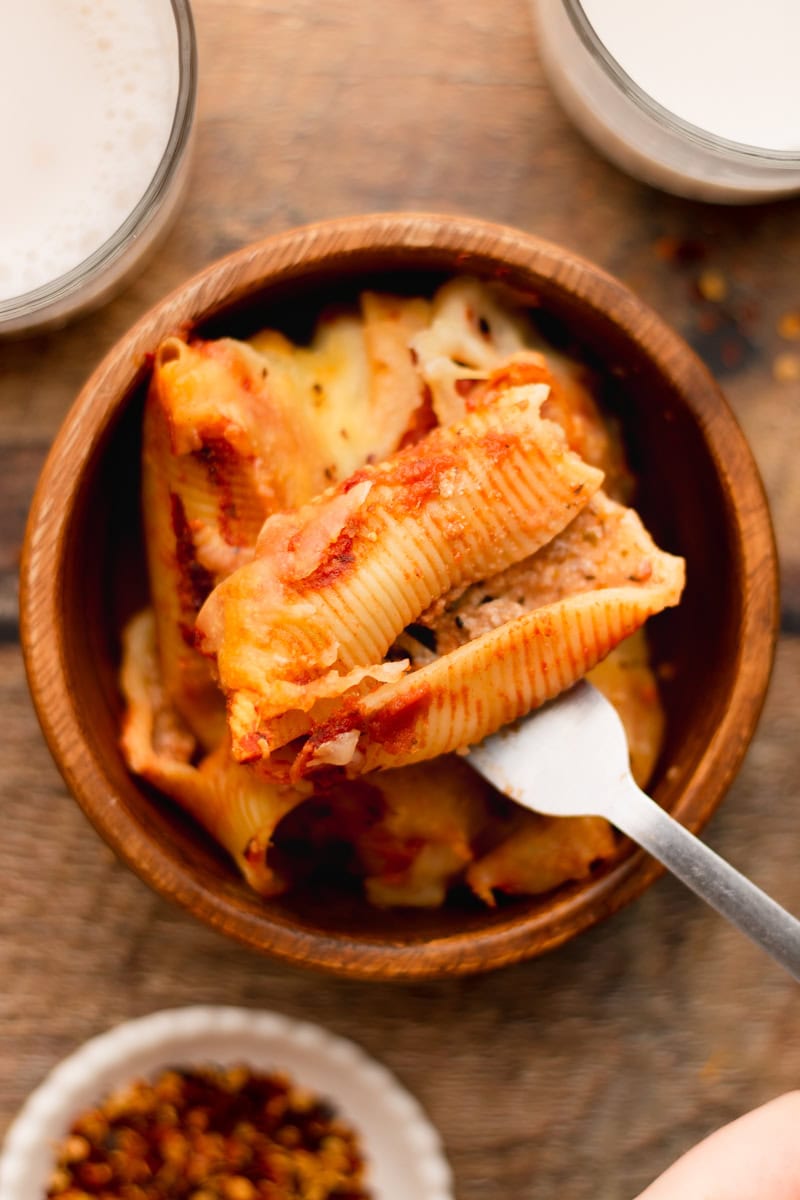 a fork with a stuffed shell showing the meat filling.