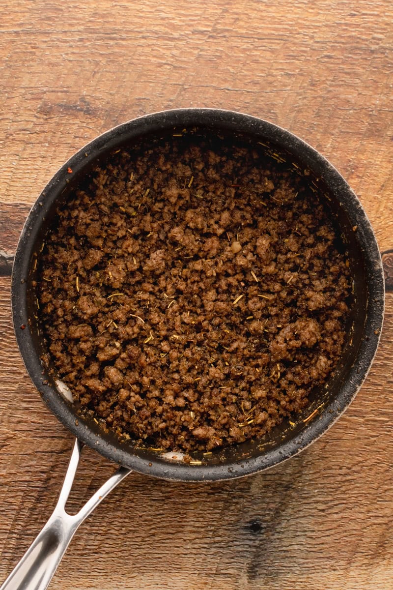 ground beef in a skillet cooking.