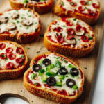 Garlic Bread Pizza on a wood cutting board.