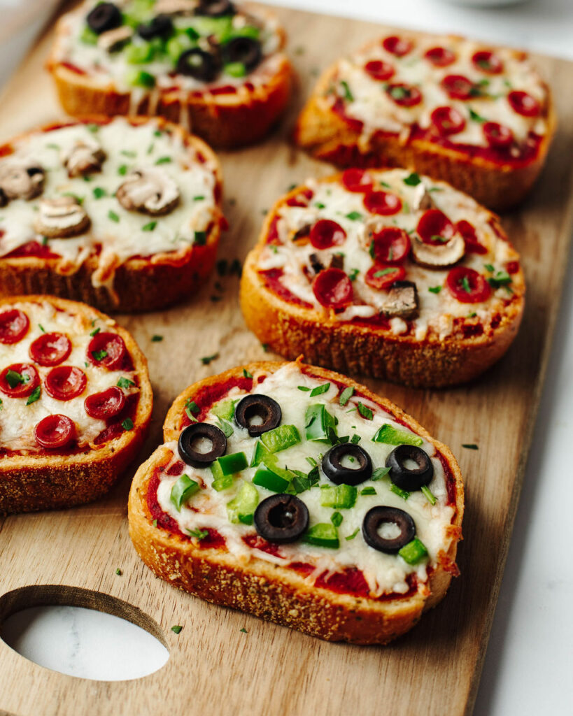 Garlic Bread Pizza on a wood cutting board.