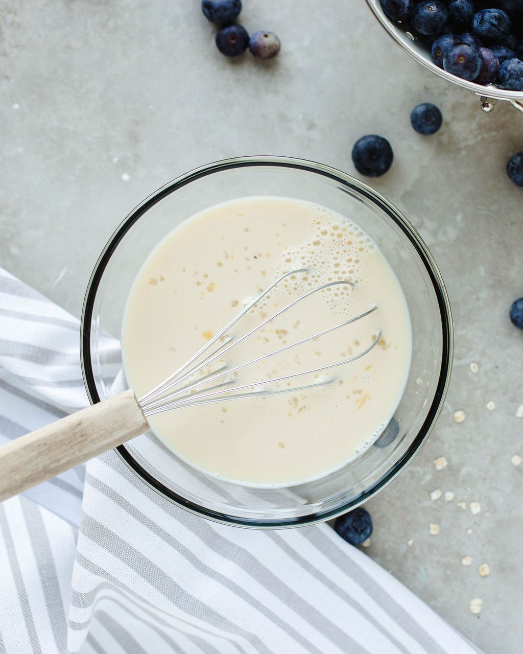 milk, egg, honey, and vanilla combined in a glass bowl.