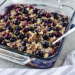 blueberry banana baked oatmeal in a glass 8x8 baking dish.
