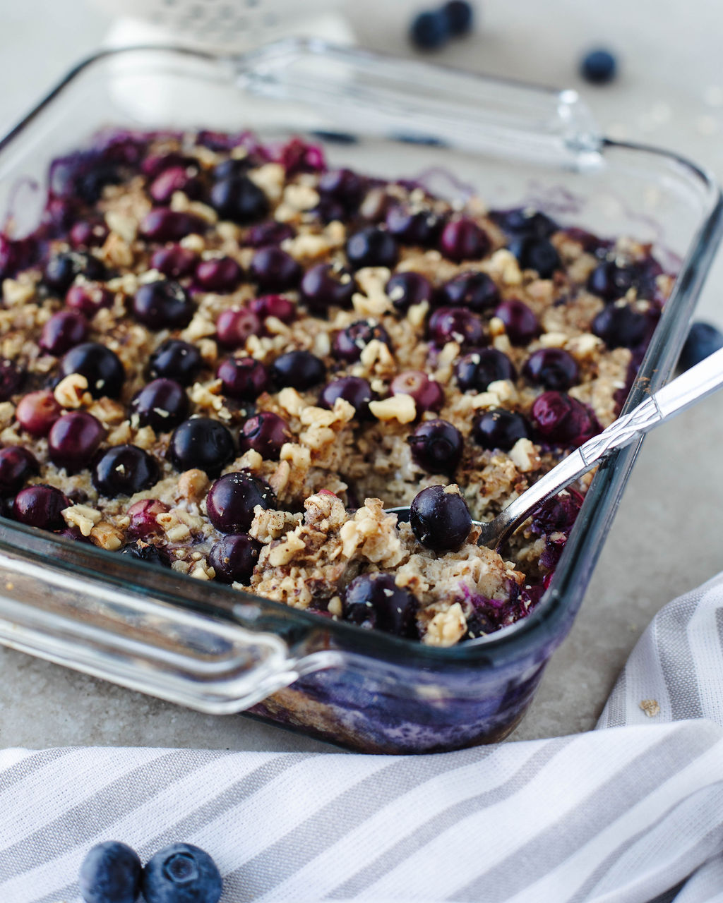 Blueberry banana baked oatmeal in glass baking dish fresh from the oven.