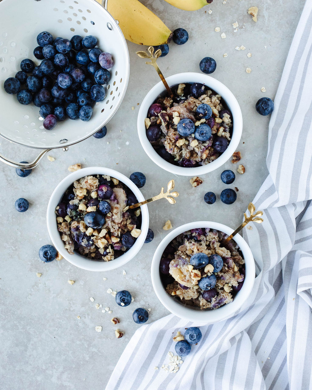 blueberry banana baked oatmeal in small white serving dishes.