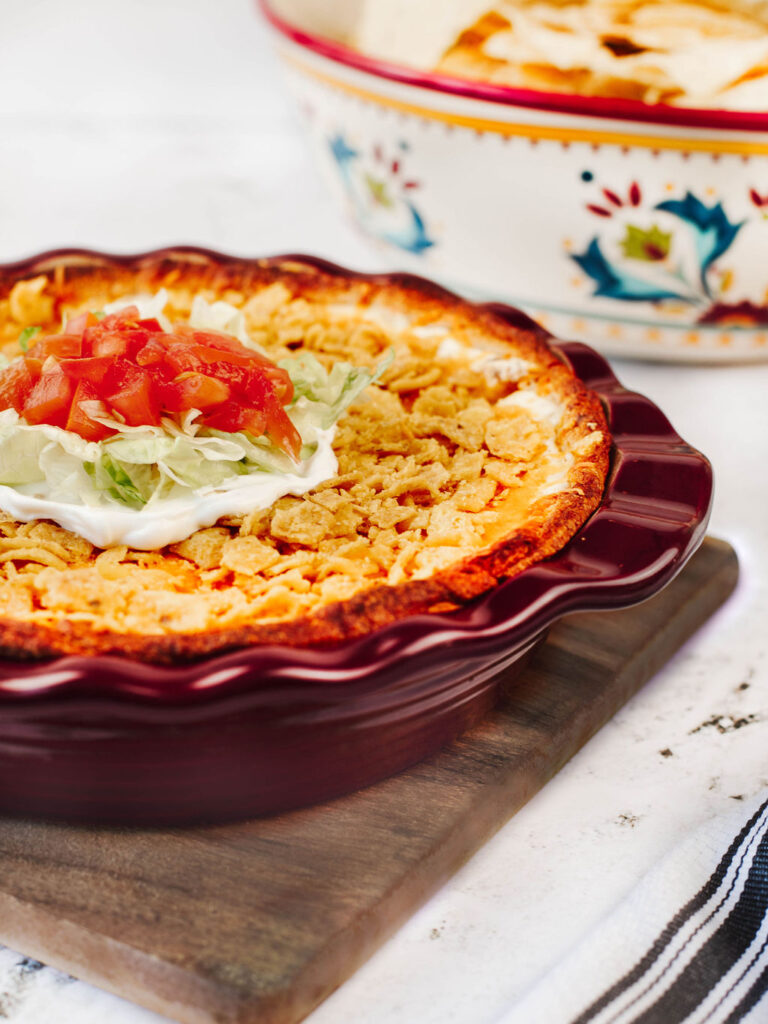tomatoes, lettuce, and sour cream topped over Frito Taco Casserole.