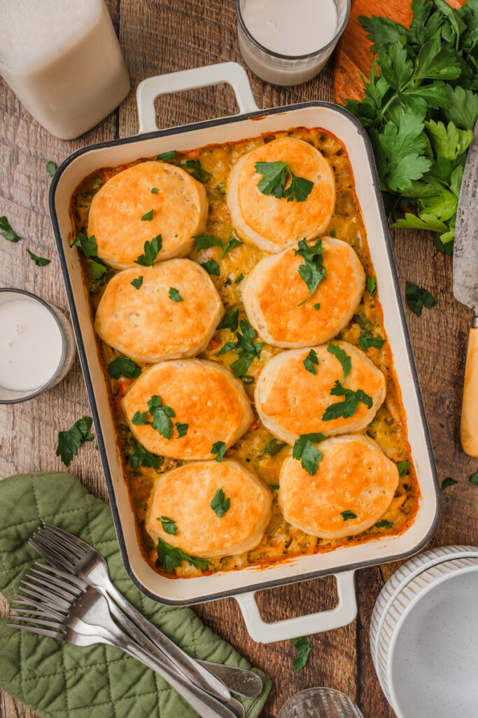 golden flaky biscuits topped over creamy chicken and vegetables.