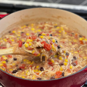 shredded chicken, beans, corn, and tomatoes combined in a dutch oven