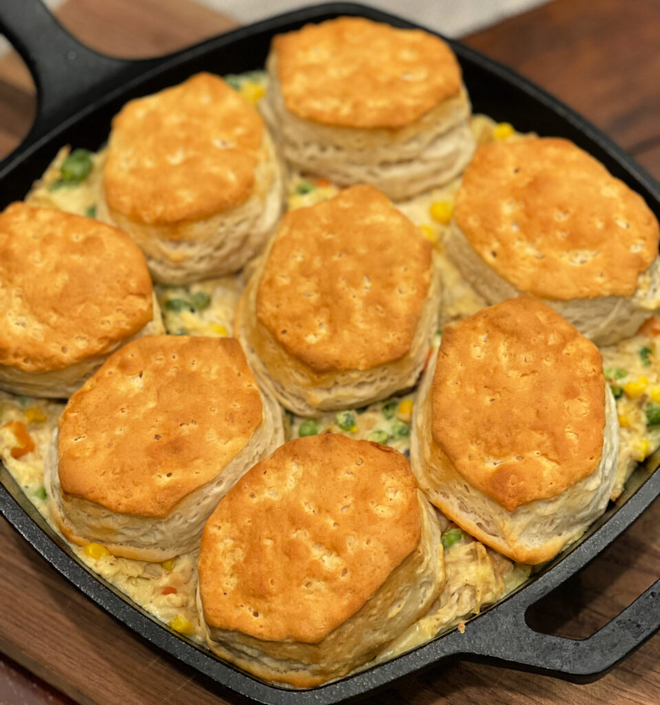 biscuits on top of chicken and vegetables combined into a shortcut chicken pot pie