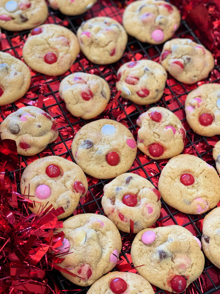 festive red, white, and pink M & M cookies with chocolate chips throughout