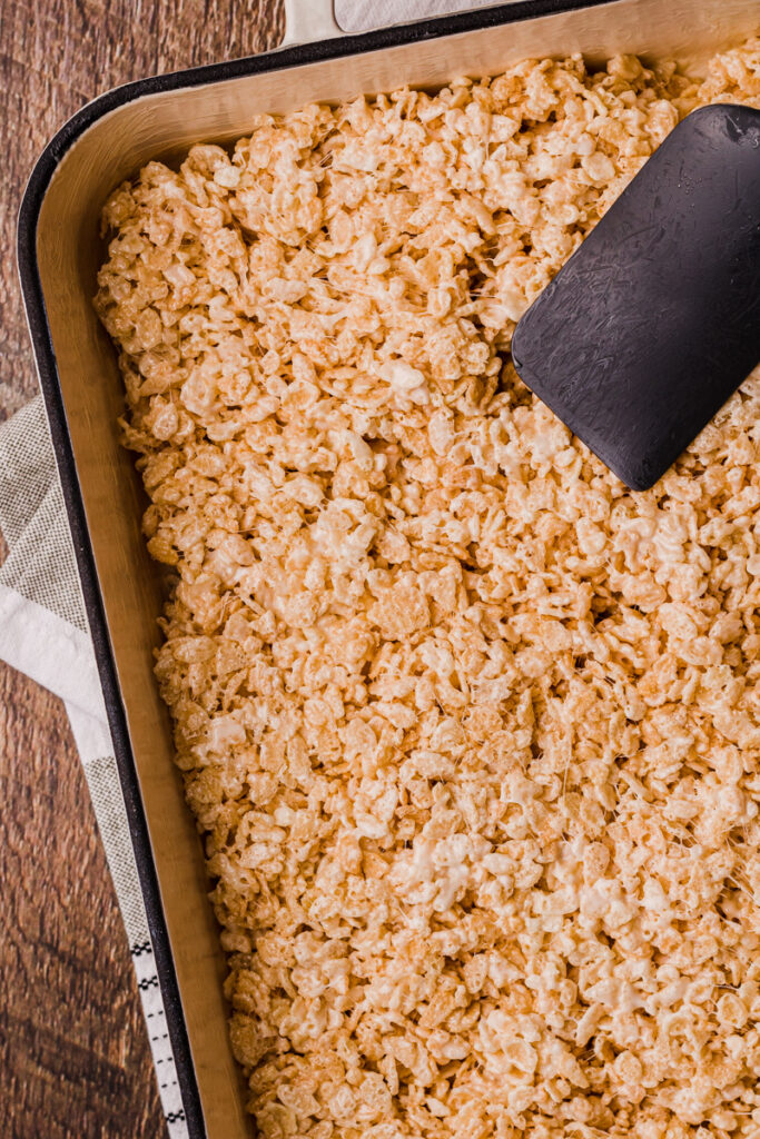 gently spreading rice krispy mixture into a prepared pan
