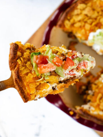 a slice of Frito taco pie on a serving spoon.