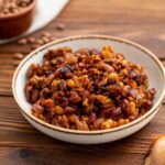 beef, bacon, and beans combined into a cowboy beans dish