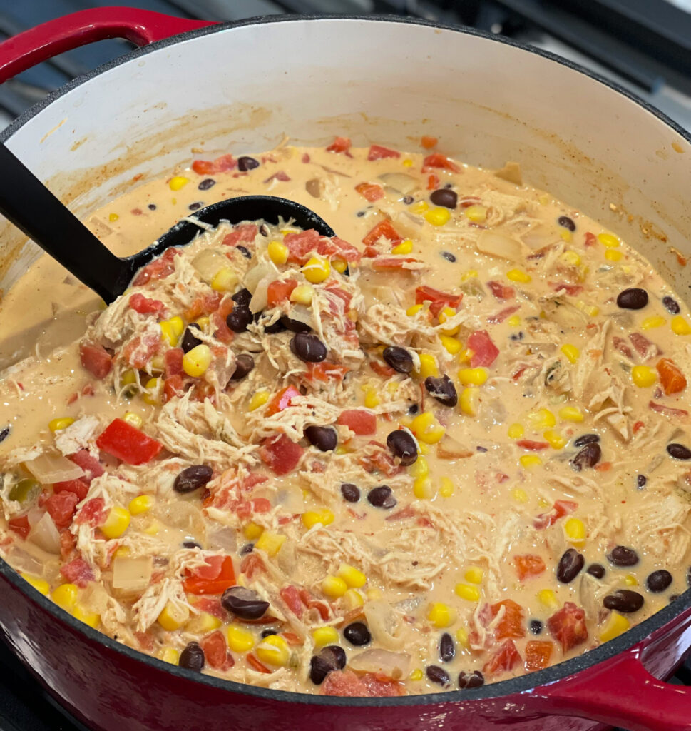 corn, beans, chicken and peppers combined into a flarful tex mex soup